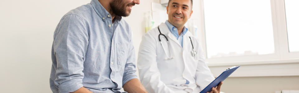 Physician reviewing case with patient in consultation room